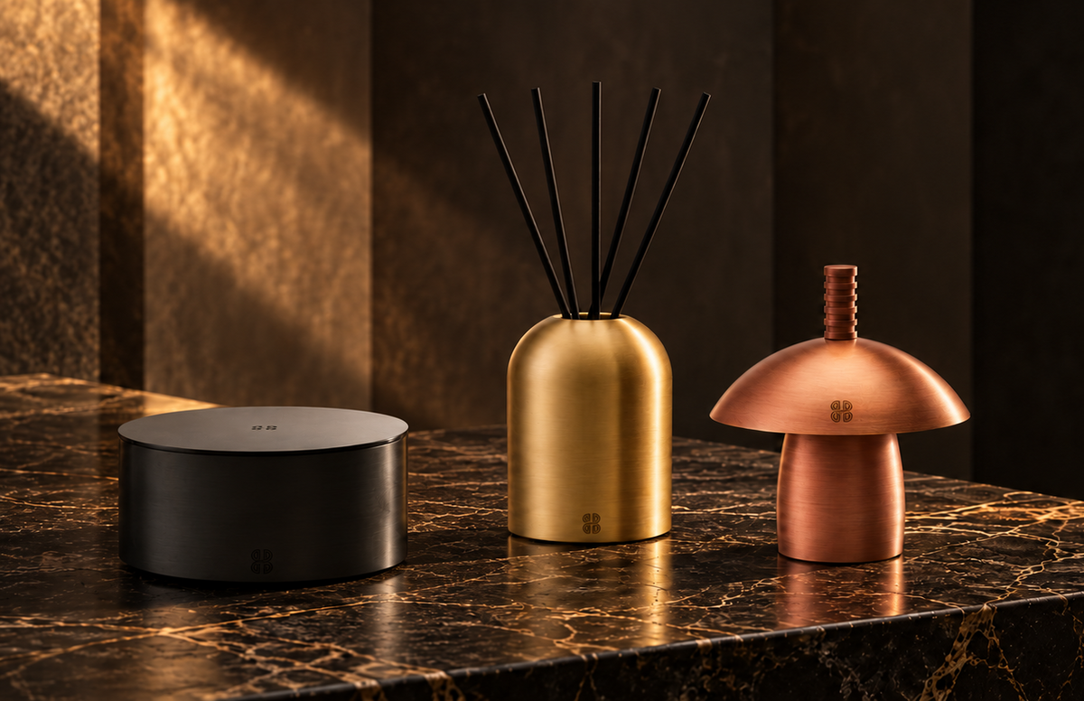 Born Brass objects in matte black, satin gold and rose gold on dark marble