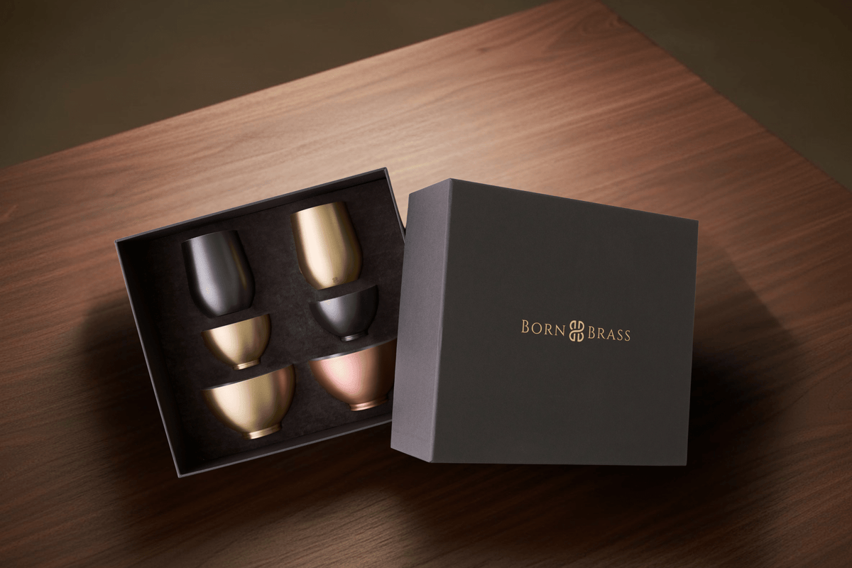 Modern brass gift set with snack bowls and cocktail glasses styled for elegant entertaining